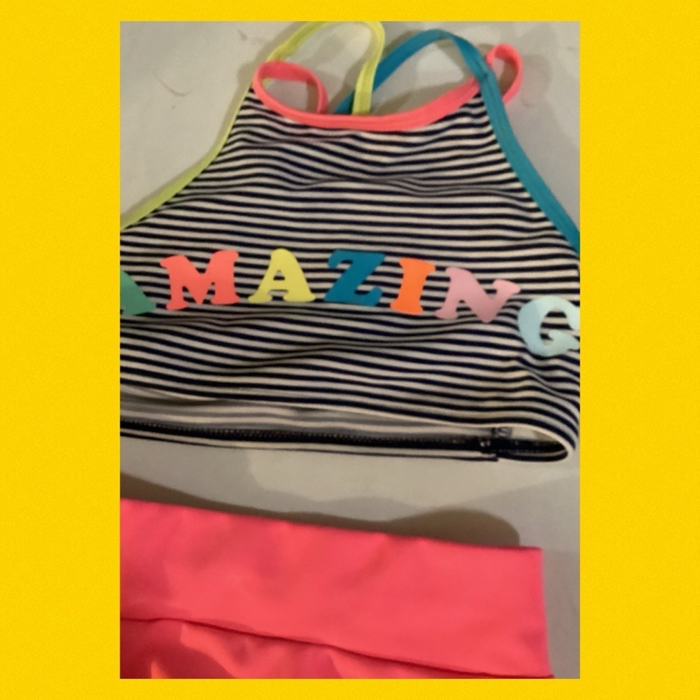 Little girl, two-piece with pink bottoms and stripe black-and-white top. 10